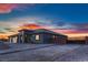 A modern single-story house features gravel landscaping and a brick-paved driveway leading to an automated gate at 4740 W Agate Ave, Las Vegas, NV 89139