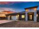 Close-up view of a house with a three-car garage and a modern entrance with beautiful brickwork at 4740 W Agate Ave, Las Vegas, NV 89139