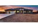 Stunning single-story home featuring a three-car garage and modern stone accents at sunset at 4740 W Agate Ave, Las Vegas, NV 89139