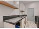 Bright laundry room with modern sink and dark granite counters at 4740 W Agate Ave, Las Vegas, NV 89139