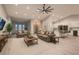 Spacious living room with neutral tones, recessed lighting, plush seating, and an open layout to the kitchen at 4740 W Agate Ave, Las Vegas, NV 89139