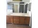 This bright bathroom features a double sink vanity and shower/tub combo with sliding door at 5115 Blossom Ave, Las Vegas, NV 89142