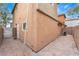 The side of a home featuring a brick patio, stucco siding and a window at 5280 Shreve Ave, Las Vegas, NV 89156