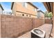 Backyard featuring a brick patio, air conditioning unit, and a block wall at 5280 Shreve Ave, Las Vegas, NV 89156