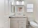 Bright bathroom featuring a granite vanity with square sink, white cabinets, and a framed mirror with modern lighting at 5280 Shreve Ave, Las Vegas, NV 89156