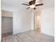 A bedroom featuring hardwood flooring, a ceiling fan with lighting, a window with coverings, and a closet at 5280 Shreve Ave, Las Vegas, NV 89156
