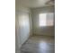 Bedroom featuring light colored floors, white closet, and a window with blinds at 5280 Shreve Ave, Las Vegas, NV 89156