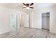 Light-filled bedroom with an ensuite bathroom and closet featuring light-colored walls and wood flooring at 5280 Shreve Ave, Las Vegas, NV 89156