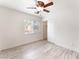 A bedroom featuring hardwood flooring, a ceiling fan with lighting, a window with coverings, and a sliding door closet at 5280 Shreve Ave, Las Vegas, NV 89156