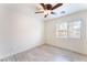 An airy bedroom featuring hardwood flooring, a ceiling fan with lighting, and a window with coverings at 5280 Shreve Ave, Las Vegas, NV 89156
