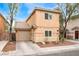 Home featuring a two-car garage, complemented by desert landscaping for low maintenance at 5280 Shreve Ave, Las Vegas, NV 89156