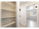Hallway featuring built in storage and a laundry room with views to a bedroom at 5280 Shreve Ave, Las Vegas, NV 89156