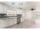 Modern kitchen features stainless steel appliances and white cabinets, open to living area at 5280 Shreve Ave, Las Vegas, NV 89156