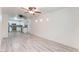 Open-concept living room featuring gray wood-look floors and modern ceiling fans at 5280 Shreve Ave, Las Vegas, NV 89156