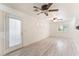 Bright and airy living room featuring wood-look floors and a glass patio door at 5280 Shreve Ave, Las Vegas, NV 89156