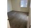 This bedroom features wood-look floors, neutral walls, and a sun-lit window at 5284 Wellesley Ave, Las Vegas, NV 89122
