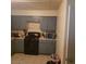 Functional kitchen featuring gray cabinets, black appliances, and tile flooring at 5284 Wellesley Ave, Las Vegas, NV 89122