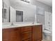 Bathroom featuring a dual sink vanity with wood cabinets and a shower-tub combo at 5452 Tinker Toy Ave, Las Vegas, NV 89139