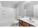 Bathroom with a shower-tub combination, a toilet, and a wood-grain vanity with a vessel sink and a large mirror at 5452 Tinker Toy Ave, Las Vegas, NV 89139