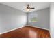Bedroom featuring wood floors, a ceiling fan, and a window with bright light at 5452 Tinker Toy Ave, Las Vegas, NV 89139