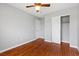 Bedroom with hardwood floors, ceiling fan, grey walls, and closet at 5452 Tinker Toy Ave, Las Vegas, NV 89139