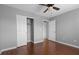 Bedroom with hardwood floors, ceiling fan, grey walls, and closet at 5452 Tinker Toy Ave, Las Vegas, NV 89139