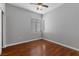 Bright bedroom with hardwood floors, natural light, and a ceiling fan for added comfort at 5452 Tinker Toy Ave, Las Vegas, NV 89139
