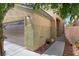 Side exterior showcasing a garage and walkway, surrounded by meticulous landscaping and greenery at 5452 Tinker Toy Ave, Las Vegas, NV 89139