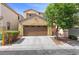 Inviting home exterior with a manicured lawn, large trees, and a two-car garage at 5452 Tinker Toy Ave, Las Vegas, NV 89139