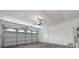 Clean garage with garage door, high ceilings, and lighting at 5452 Tinker Toy Ave, Las Vegas, NV 89139