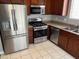 This updated kitchen features stainless steel appliances and warm wood cabinetry at 5452 Tinker Toy Ave, Las Vegas, NV 89139