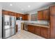 Modern kitchen with stainless steel appliances, granite countertops, and wood cabinets at 5452 Tinker Toy Ave, Las Vegas, NV 89139