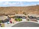 Aerial view of a desert home with mature landscaping, circular driveway, and mountain views at 574 Desert Tortoise Way, Mesquite, NV 89027