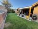 This backyard offers a cozy outdoor seating area and a lush, green lawn at 574 Desert Tortoise Way, Mesquite, NV 89027