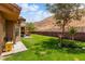 Grassy backyard with low-maintenance landscaping and partial mountain views at 574 Desert Tortoise Way, Mesquite, NV 89027