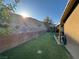 This backyard features a well-kept lawn, shade tree, and a brick retaining wall at 574 Desert Tortoise Way, Mesquite, NV 89027