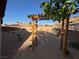 The desert-landscaped backyard features a wooden pergola with a view of the distant mountains at 574 Desert Tortoise Way, Mesquite, NV 89027