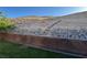 The backyard has a tiered landscape with a staircase up the hill, and a brick retaining wall at 574 Desert Tortoise Way, Mesquite, NV 89027