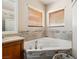 Corner soaking tub with tile surround, wood blinds, and chrome fixtures at 574 Desert Tortoise Way, Mesquite, NV 89027