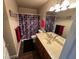 Bathroom featuring a single sink vanity with red and black themed decor at 574 Desert Tortoise Way, Mesquite, NV 89027