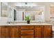 Well-lit bathroom vanity with dual sinks, decorative lighting, and an expansive mirror at 574 Desert Tortoise Way, Mesquite, NV 89027
