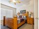 Bedroom with a wooden bed frame, carpeted floors, and natural light from the window with blinds at 574 Desert Tortoise Way, Mesquite, NV 89027