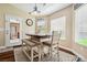 Bright dining area with white chairs, bench seating, and an exterior door for indoor/outdoor living at 574 Desert Tortoise Way, Mesquite, NV 89027