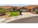 Charming single-story home features desert landscaping, a stone facade entry, and attached two car garage at 574 Desert Tortoise Way, Mesquite, NV 89027