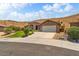 Charming single-story home features desert landscaping, a stone facade entry, and attached two car garage at 574 Desert Tortoise Way, Mesquite, NV 89027