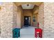 Stone porch with a black door with a floral wreath and colorful benches at 574 Desert Tortoise Way, Mesquite, NV 89027