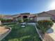 Charming home featuring a well-manicured lawn and desert-friendly landscaping at 574 Desert Tortoise Way, Mesquite, NV 89027