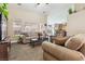 Relaxing living room featuring plush furniture, a dark wood coffee table, and a view into the kitchen at 574 Desert Tortoise Way, Mesquite, NV 89027