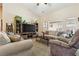 Comfortable living room with neutral tones, a large TV, and large windows providing natural light at 574 Desert Tortoise Way, Mesquite, NV 89027