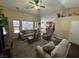 Spacious living room with ceiling fan, plush furniture, and ample natural light at 574 Desert Tortoise Way, Mesquite, NV 89027